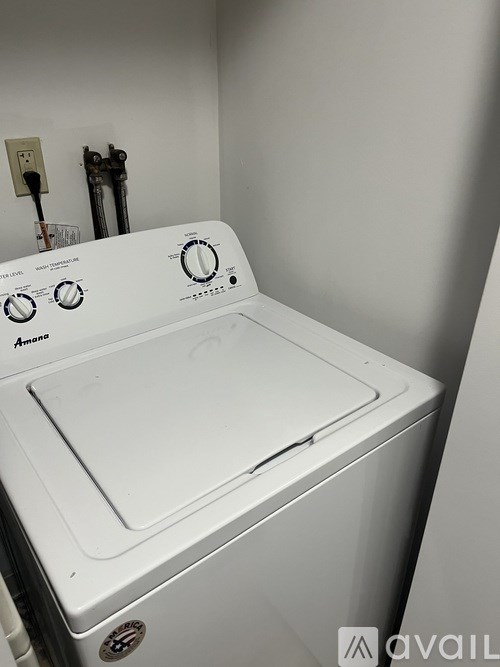 A white washing machine with the brand name Amana on the front.
