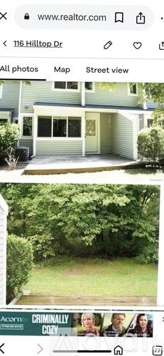 A kitchen with white cabinets and a blue tile backsplash.