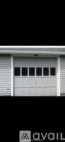 A bathroom with a toilet, sink, and a mirror.