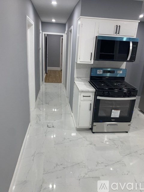 A kitchen with a white oven and microwave.