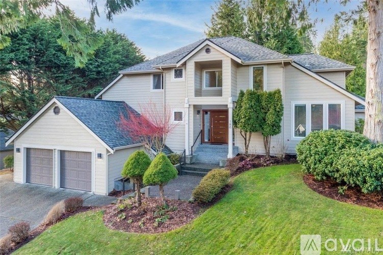 A house with a red tree in front of it.