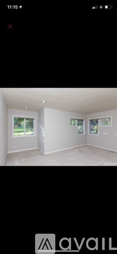 A room with white walls and a window.