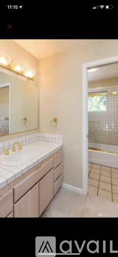 A bathroom with a sink, mirror, and tiled floor.