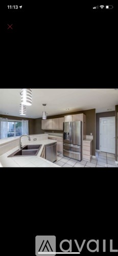 A modern bathroom with a large mirror and a sink.