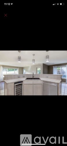 A kitchen with a stove top oven and a refrigerator.