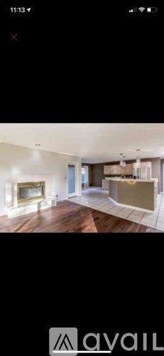 A modern living room with a fireplace and a television.