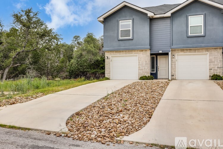 A two-story house with a garage is available for sale.
