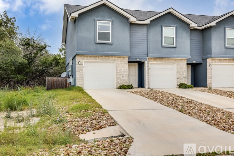 A house with a grey exterior and a white garage door.