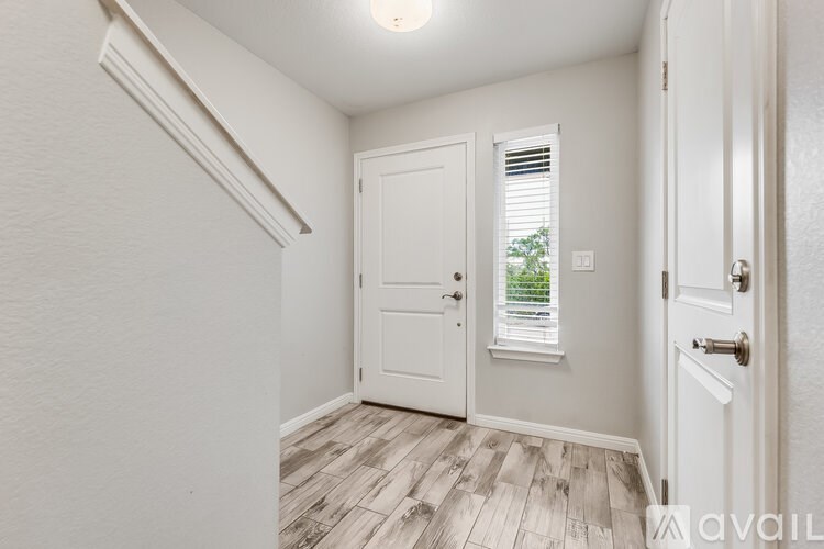 A white door with a window above it in a room.