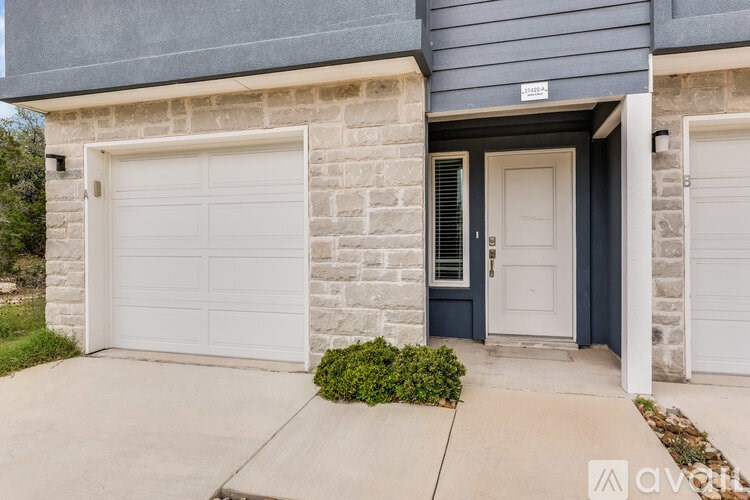 A house with a white garage door and a blue door.