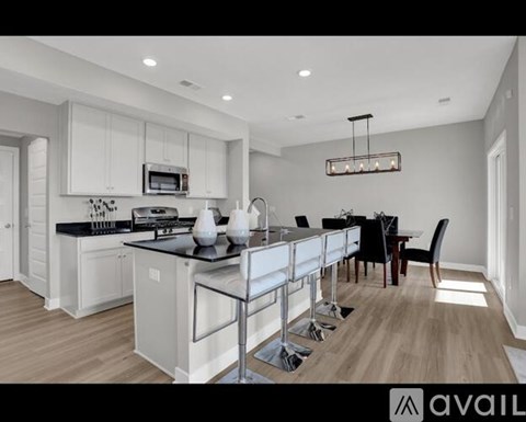 A modern kitchen with a dining table set for four.