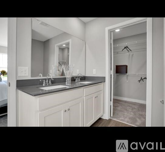 A bathroom with a sink, mirror, and a cabinet.