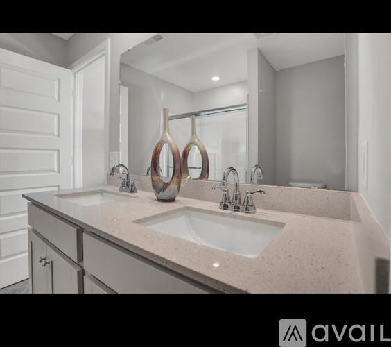 A bathroom with a sink and a mirror.