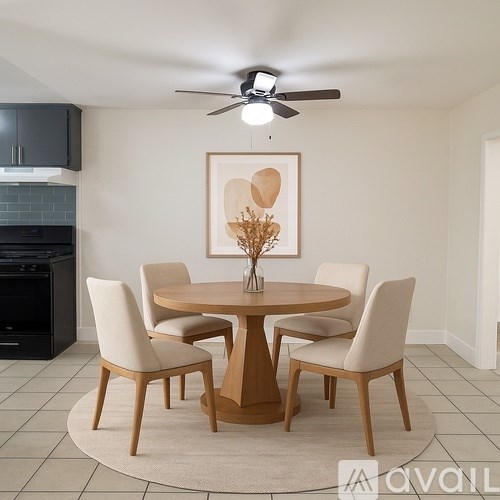 A modern dining room with a round table and chairs.