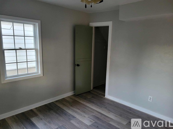 A room with a window and a door.