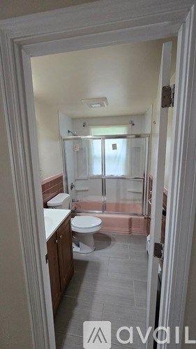 A bathroom with a toilet and a shower.