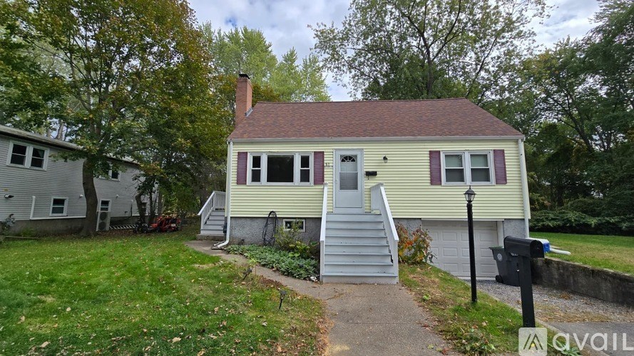 A house with a green front yard and a mailbox on the right.