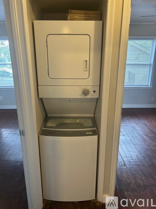 A white dishwasher is in a cabinet.