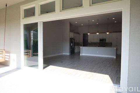 A spacious kitchen and living room with a dining table and chairs.