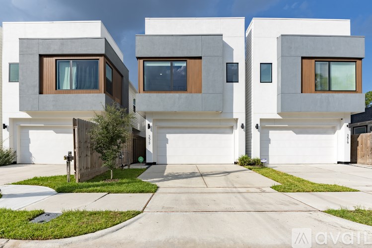 Two modern houses with white walls and brown windows.