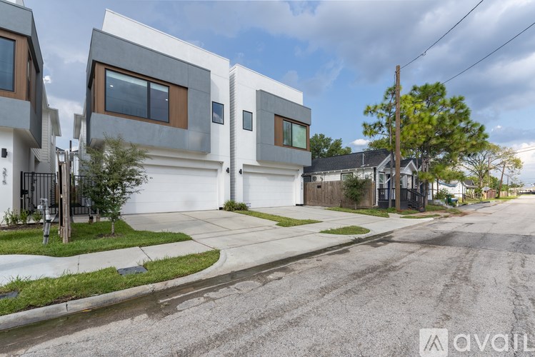 A row of modern houses with a street in front.