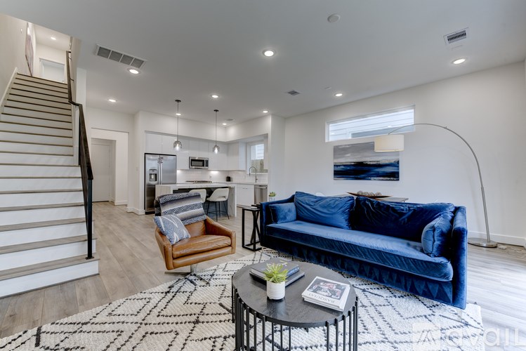 A living room with a blue couch and a coffee table.