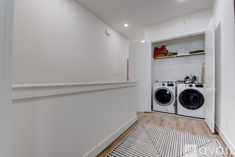 A laundry room with two front-loading washing machines.