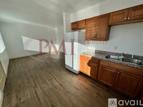 A kitchen with wooden cabinets and a white oven.