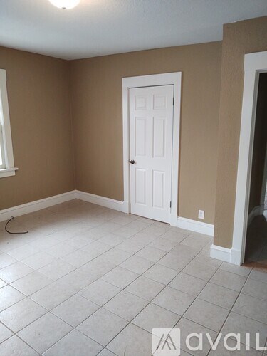 A room with a white door and a window.