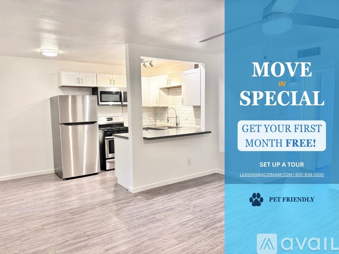 A room with a kitchen area and a sign offering a free first month.