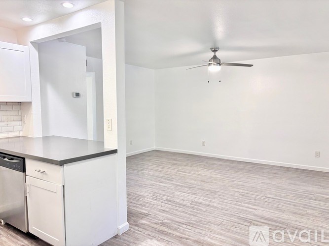 A kitchen with a dishwasher and a fan.