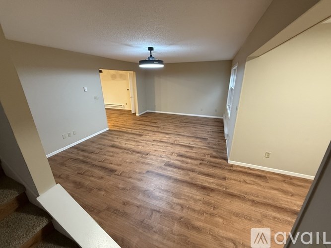 A room with wooden flooring and a ceiling light.