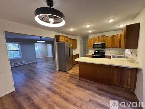 A kitchen with wooden cabinets and a refrigerator.