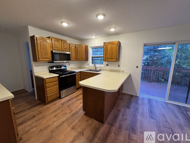 A kitchen with wooden cabinets and a white countertop.