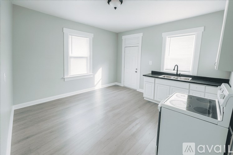 A kitchen with a dishwasher and a window.
