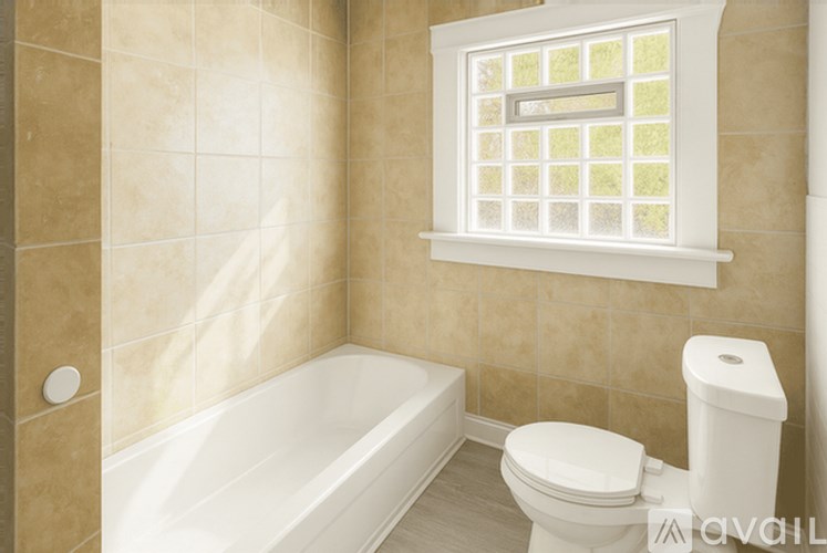 A bathroom with a white tub, toilet, and window.
