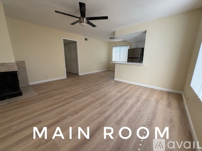 A kitchen with a stainless steel refrigerator, microwave, and oven.