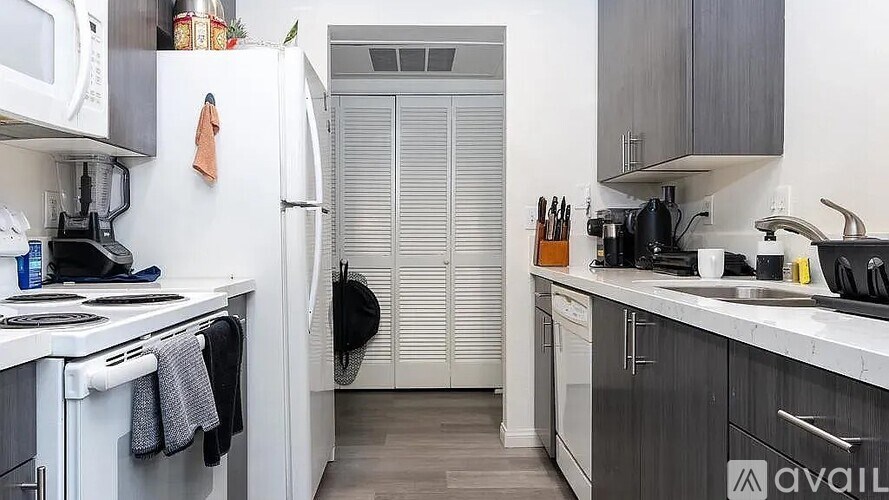 A kitchen with a white refrigerator and a white stove.