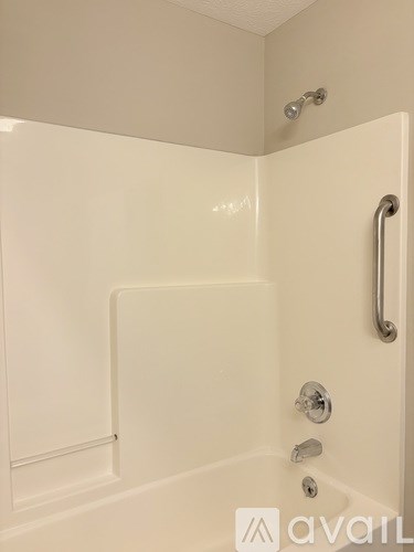 A white bathroom shower with Avail logo.
