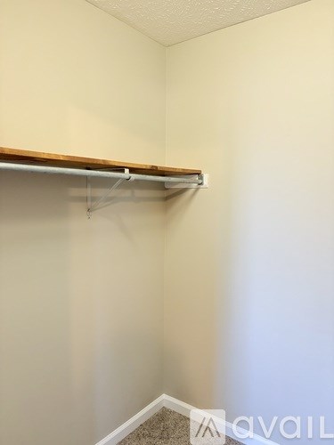 A wall with a shelf and a white wall.