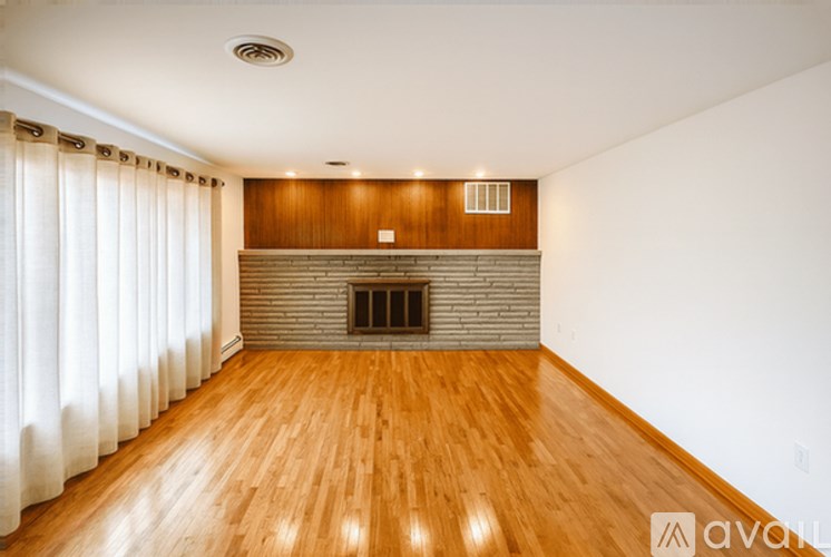 A room with wooden floors and a fireplace.