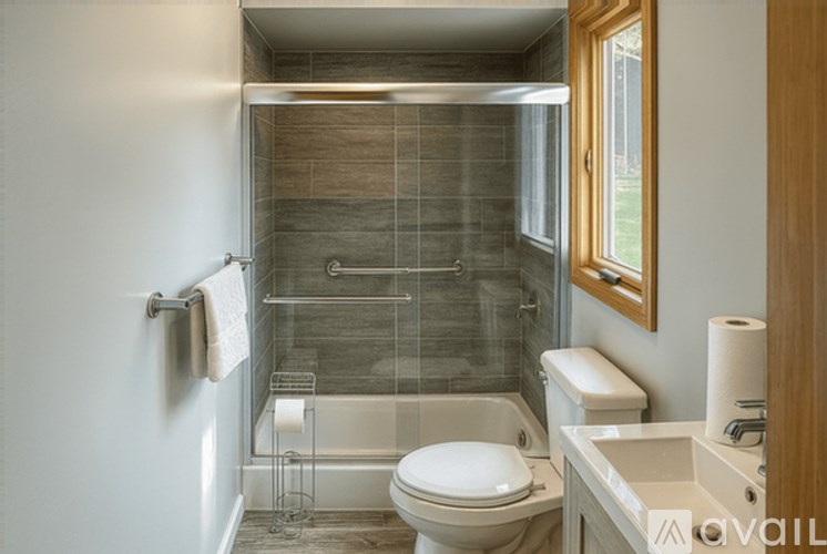 A bathroom with a toilet, sink, and shower.