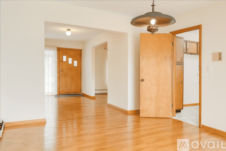 A room with wooden floors and a large wooden door.