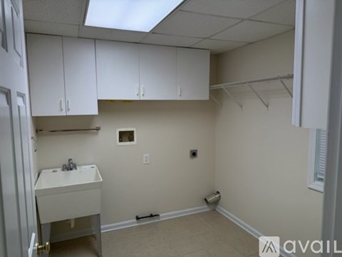 A small bathroom with a sink and a toilet paper roll.