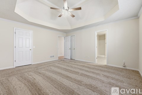 A room with a ceiling fan and a window.