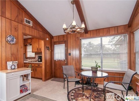 A cozy kitchen with a table and chairs.