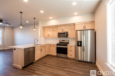 A kitchen with wooden cabinets and stainless steel appliances.
