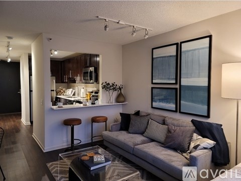 A living room with a grey couch and a coffee table.