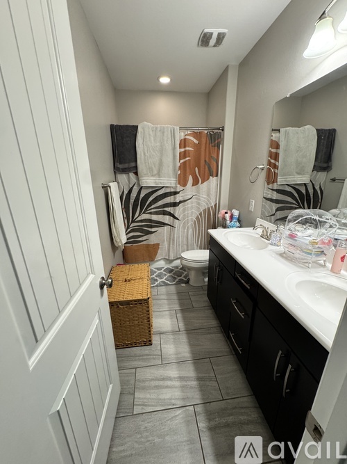 A bathroom with a white door and a white sink.