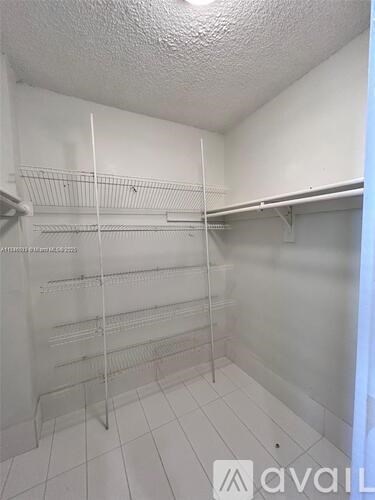 A white walk in freezer with shelves and no items.